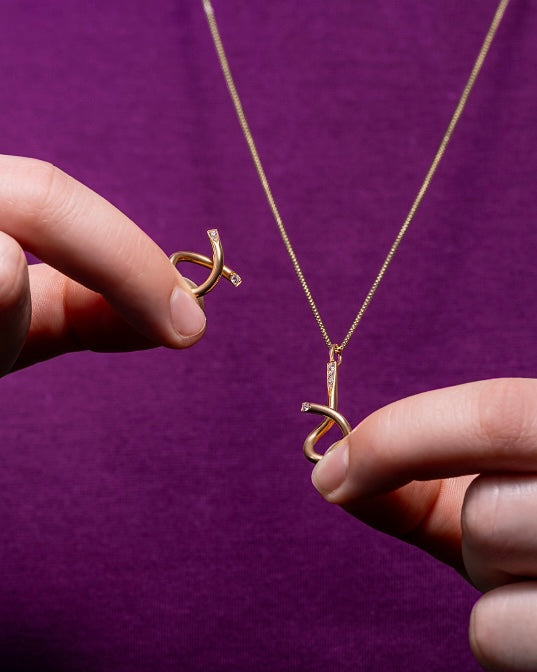 Adair jewelry brain teaser necklace with a purple shirt
