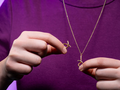Collection A yellow gold brain teaser necklace S, ethical 18k gold and lab-grown diamond, woman play with hands